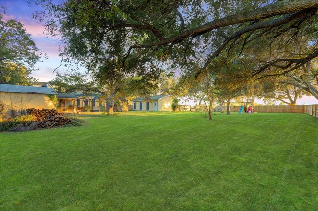 FENCED IN BACK YARD. A MORGAN STORAGE BUILDLING ON THE LEFT. | Image 30
