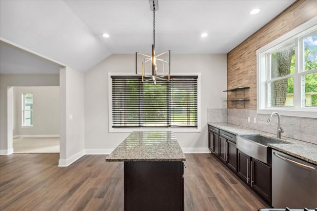 Kitchen with dishwasher, a sink, a chandelier, healthy amount of natural light, and vaulted ceiling | Image 10