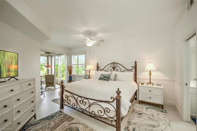 Bedroom with baseboards, ornamental molding, a ceiling fan, access to exterior, and concrete flooring | Image 13