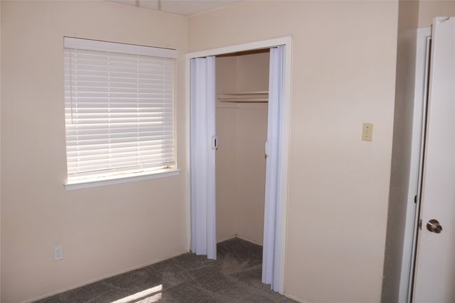 Unfurnished bedroom featuring carpet flooring and a closet | Image 10