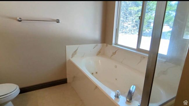 Bathroom featuring a whirlpool tub, toilet, and tile patterned floors | Image 30