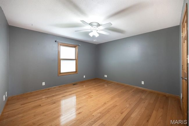Spare room featuring a ceiling fan and light wood-type flooring | Image 29