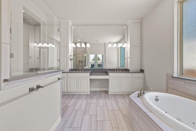 Full bath featuring vanity and a whirlpool tub | Image 15