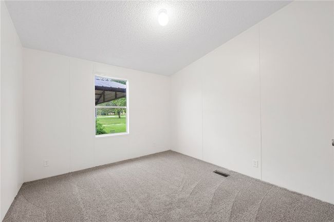 Bedroom 2 featuring carpet floors and a textured ceiling | Image 18