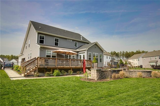 Rear view of property featuring a deck and a lawn | Image 42