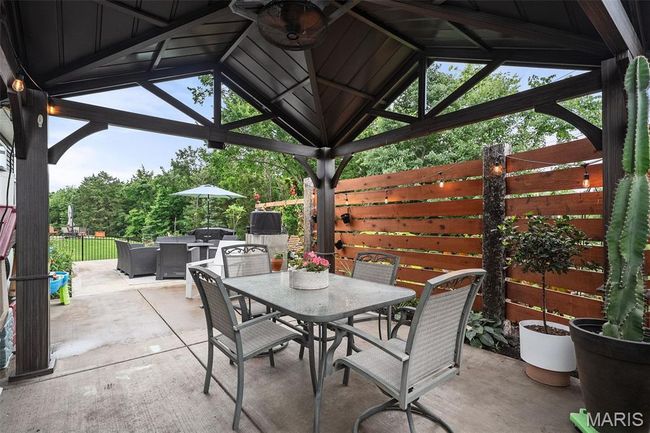 View of patio featuring a gazebo and outdoor dining area | Image 42