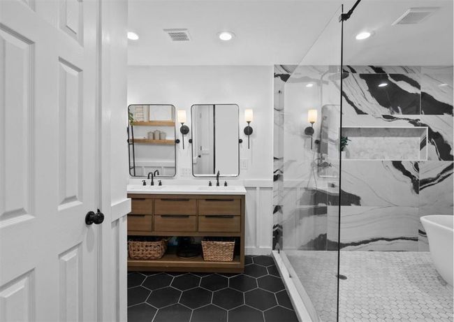 Gorgeous ensuite spa like bath with designer tile walk-in shower and freestanding soaker tub. | Image 6