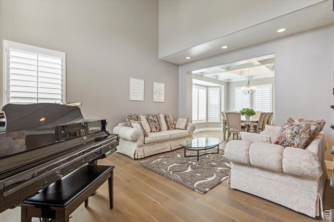 Living area featuring a chandelier, wood finished floors, recessed lighting, and beam ceiling | Image 6