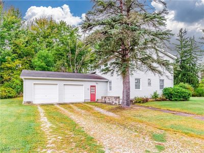 View of front of home with a garage and a front lawn | Image 3