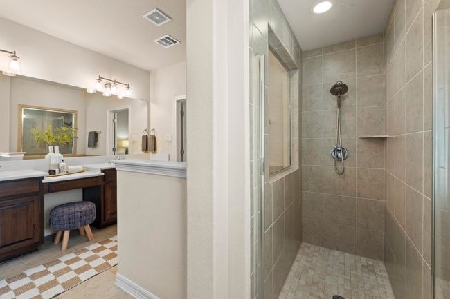 Bathroom with tiled shower, vanity, tile patterned flooring, and recessed lighting | Image 24