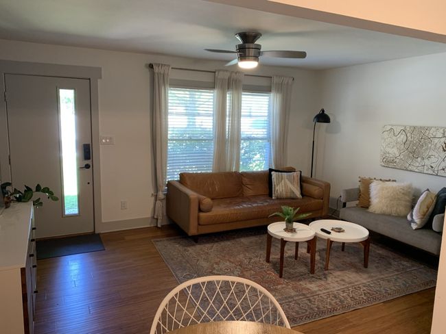 Living room featuring wood finished floors, ceiling fan, and baseboards | Image 4