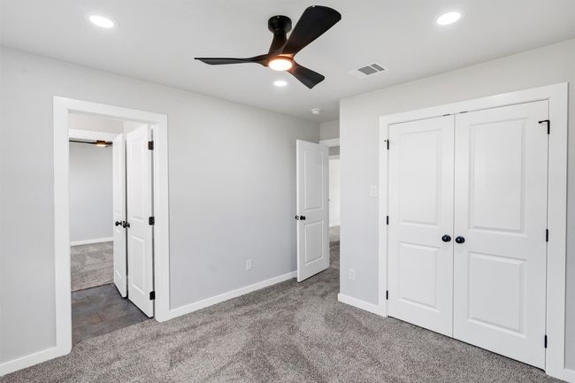 Unfurnished bedroom featuring carpet floors, baseboards, recessed lighting, and a closet | Image 32