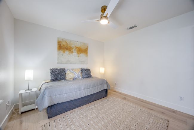 Bedroom with wood finished floors and a ceiling fan | Image 27