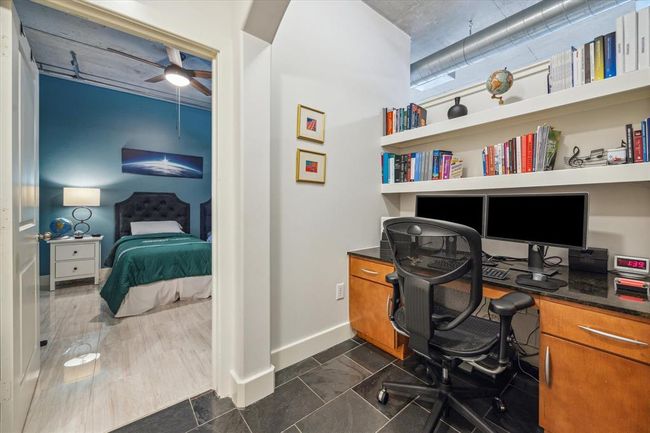 Spacious study area (approx. 6x5) featuring built-in shelving and storage. | Image 8