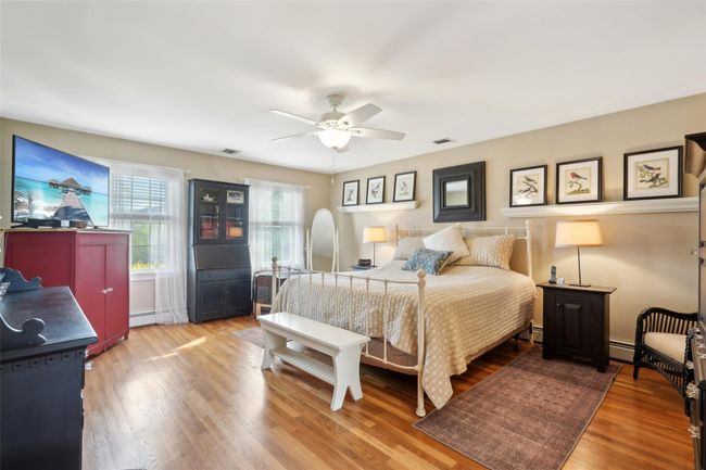 Bedroom featuring baseboards and light wood-type flooring | Image 29