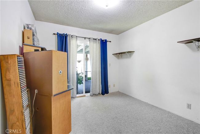 4th bedroom with slider door access to garage. | Image 18