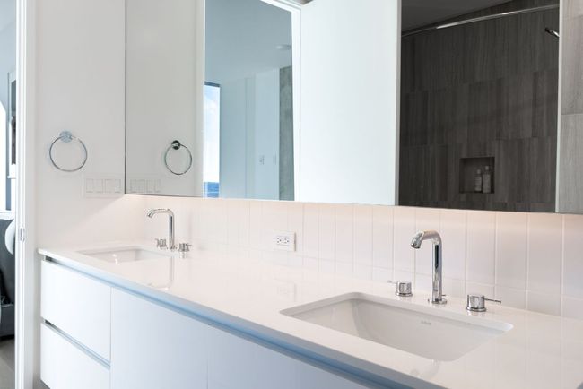 Full bathroom with decorative backsplash, double vanity, and a sink | Image 14