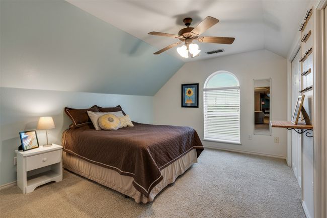 Bedroom featuring lofted ceiling, a ceiling fan, baseboards, and carpet floors | Image 28