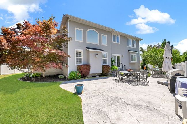 View of front of property with fence, stucco siding, a patio area, and a front lawn | Image 42