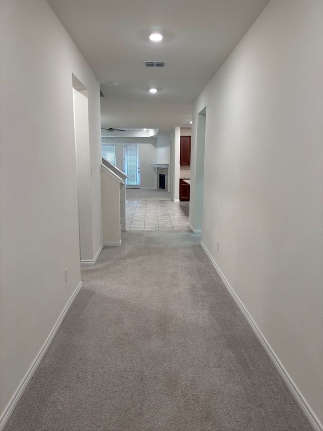 Corridor with light carpet and baseboards | Image 22