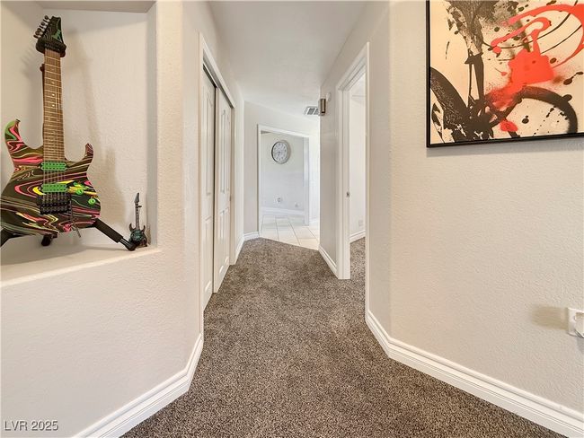 Hallway with visible vents, baseboards, and carpet floors | Image 35