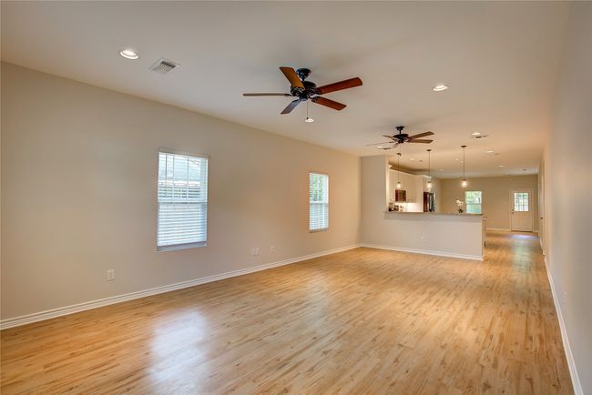 Unfurnished living room with light wood-style floors, recessed lighting, and ceiling fan | Image 4
