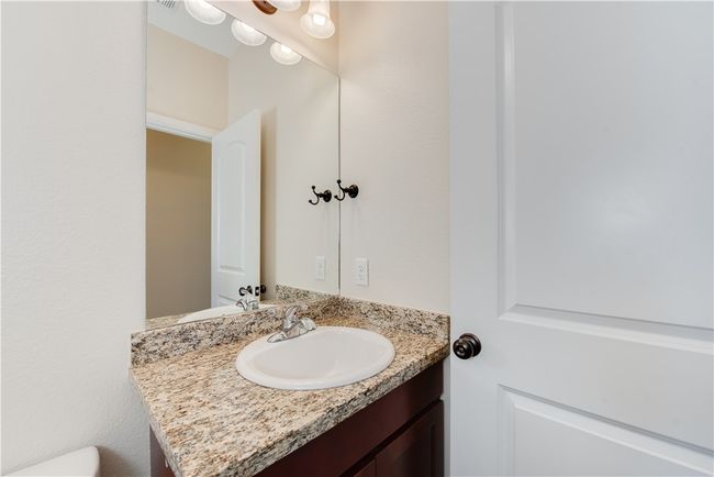 Bathroom featuring toilet and vanity | Image 8