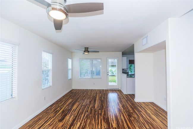 Living room/dining room view to the back door and kitchen area. | Image 10