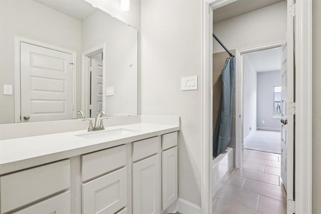 Thoughtfully designed shared bath with dual sinks and private tub area | Image 36