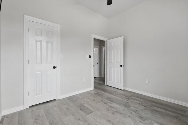 Unfurnished bedroom featuring wood finished floors, baseboards, and a ceiling fan | Image 29