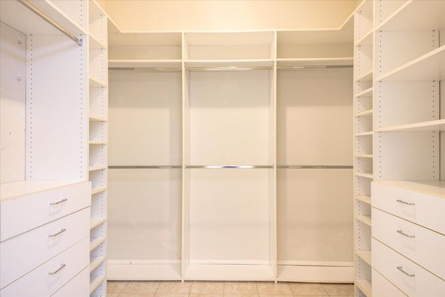 Spacious closet with light tile patterned flooring | Image 19
