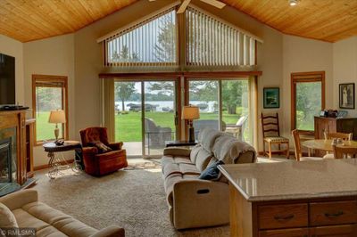 Open & airy, the wall of windows amplifies the vaulted ceiling. | Image 3