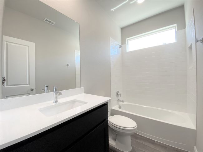 Bathroom featuring shower / bathtub combination, vanity, and wood finished floors | Image 11