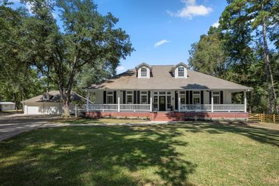 This home features an extra-large front porch, perfect for relaxing and enjoying the outdoors. | Image 1