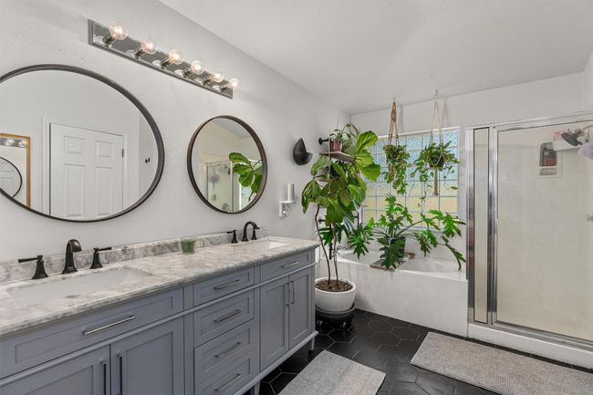 Full bath with double vanity, a stall shower, a bath, and tile patterned floors | Image 20