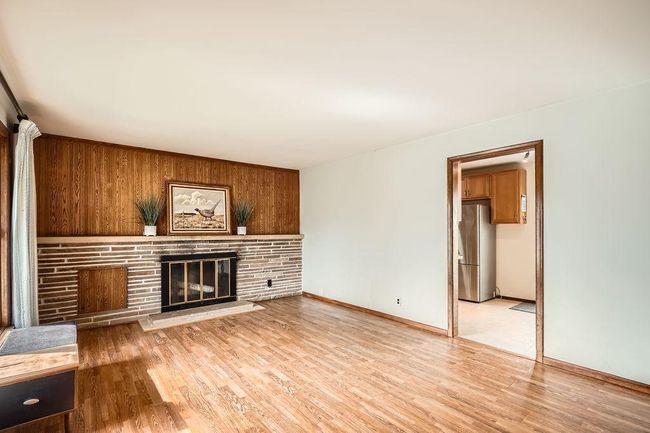 Living room with nice big windows and a wood burning fireplace. | Image 6