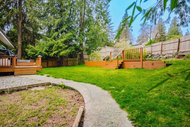 View of yard featuring a fenced backyard and a deck | Image 29