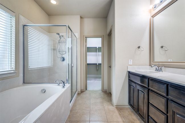 Full bathroom featuring a shower stall, vanity, a bath, and tile patterned flooring | Image 12