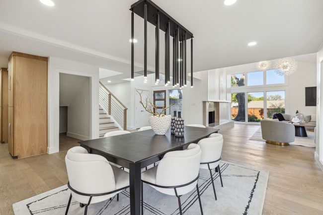 Dining area with light wood finished floors, baseboards, stairs, recessed lighting, and a fireplace | Image 10