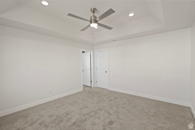 Unfurnished room featuring a raised ceiling, carpet floors, and recessed lighting | Image 18