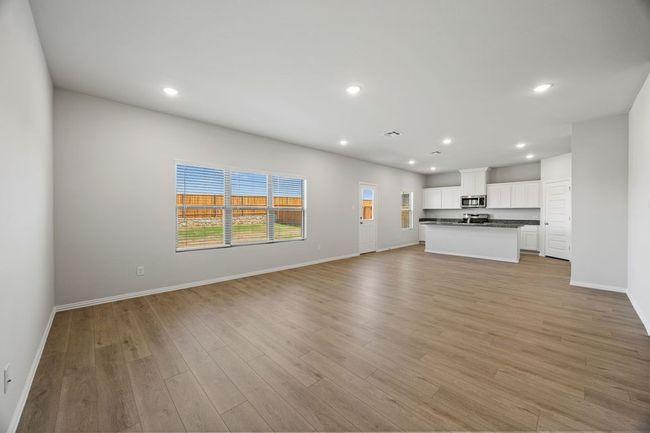 Unfurnished living room with light wood-style flooring and recessed lighting | Image 5