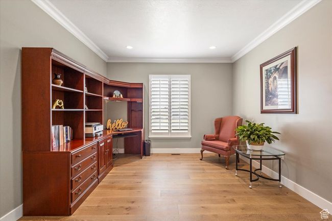 Sitting room featuring ornamental molding, an office area, baseboards, light wood finished floors, and recessed lighting | Image 17