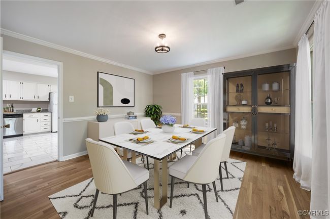 Dining room with light wood-style floors and crown molding | Image 7