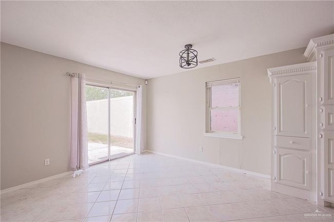 Unfurnished room featuring baseboards, visible vents, and light tile patterned floors | Image 12