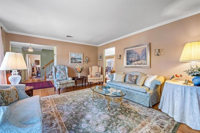 Living room with hardwood floors, crown molding. | Image 4