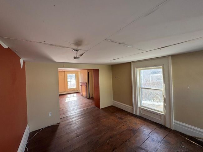Formal sitting room, facing front of house with featuring dark wood-type flooring and baseboards | Image 13