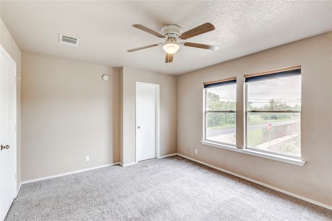 Carpeted spare room with ceiling fan and baseboards | Image 12