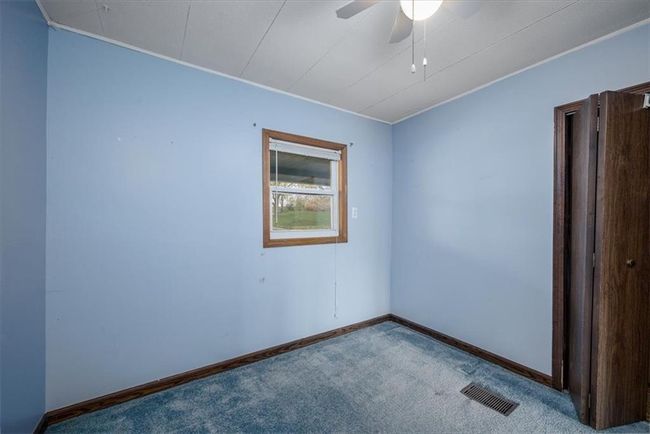 Empty room with baseboards, visible vents, carpet flooring, and crown molding | Image 24