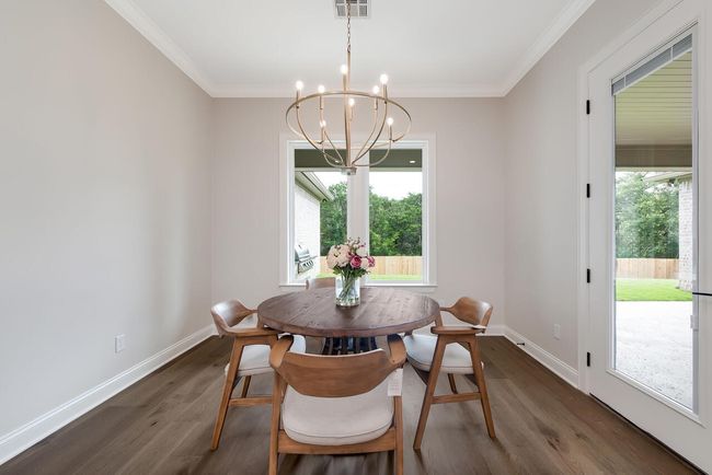Dining room featuring a chandelier, dark wood-type flooring, and crown molding | Image 21