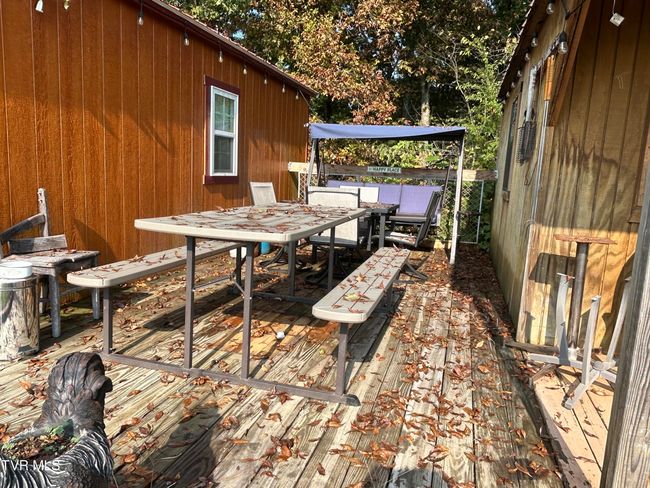 deck between the two buildings on top of the hill used for camping and family get togethers. or hunting lodges | Image 65